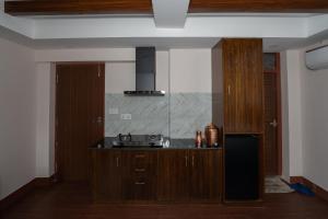 a kitchen with a sink and a stove at Fizzy Stay in Jawlakhel