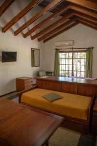 a bedroom with a large bed and a window at Green House in Villa General Belgrano