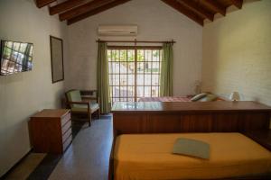 a bedroom with a large bed and a window at Green House in Villa General Belgrano +43 photos