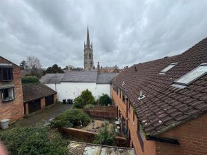 a white building with a church steeple in the background at Rooftops in Louth
