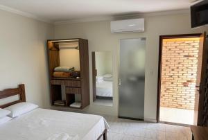 a bedroom with two beds and a mirror at Rio Preto Hotel in Formosa