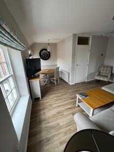 a living room with a couch and a table at Rooftops in Louth
