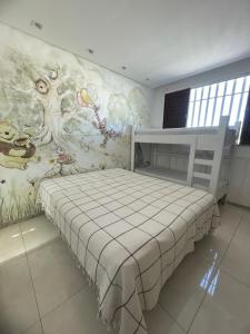 a bedroom with a bed with a painting on the wall at Star HOUSE beach in Aracaju +24 photos