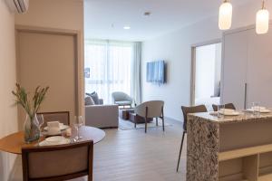 a living room with a table and a dining room at Condo Suite 2BR With View in Panama City