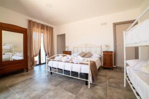 a bedroom with two bunk beds and a mirror at B&B Nonno Armando in Torchiara