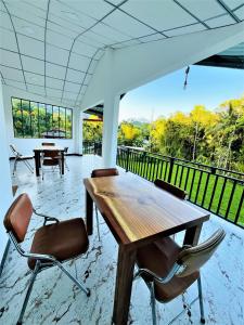 a dining room with a wooden table and chairs at Dream Arch ella in Demodera