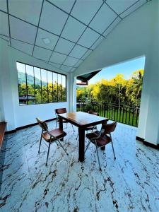 a dining room with a table and chairs and windows at Dream Arch ella in Demodera +7 photos