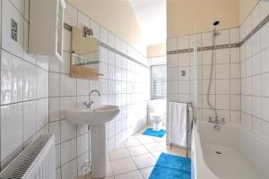 a white bathroom with a sink and a bath tub at 2 Bed in Richmond oc-ds187 in Richmond