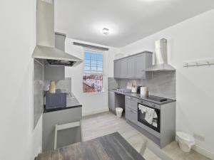 a kitchen with a sink and a stove at London Duo & Quad Rooms in Zone 2 - Willesden Green in London