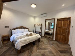 a bedroom with a large bed and a mirror at City Retreat Mega in Arusha