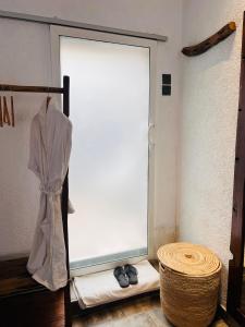 a sliding glass door with a pair of black shoes at City Retreat Mega in Arusha +32 photos
