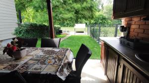a patio with a table and chairs and a yard at Ciprus nyaraló in Szarvas +17 photos