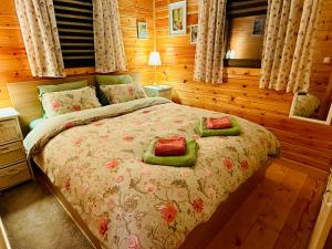a bedroom with a bed with two pillows on it at The Village Cottage in Natsovtsi