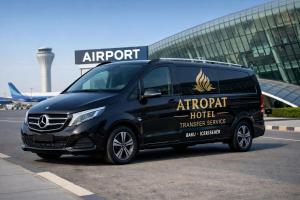 a black van parked in front of an airport at Atropat Old City Hotel in Baku
