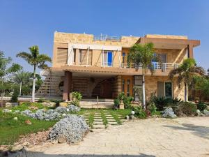 a large house with palm trees in front of it at الريف الاوربي in Cairo