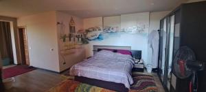 a bedroom with a bed with a painting on the wall at الريف الاوربي in Cairo