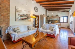 a living room with two couches and a coffee table at Petit Son Bauló in Can Picafort +53 photos