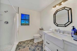a bathroom with a sink and a toilet and a mirror at Morris Ranch in Fredericksburg +23 photos