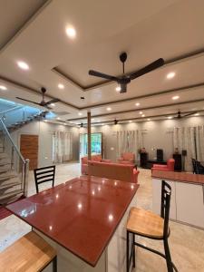 a living room with a table and a couch at The Machan Farmhouse in Noida +3 photos