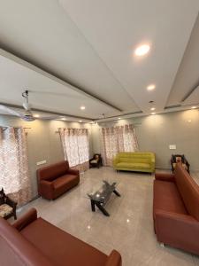 a large living room with couches and a couch at The Machan Farmhouse in Noida