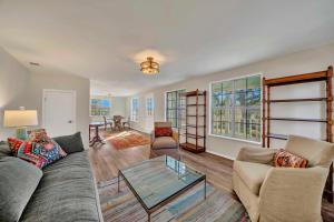 a living room with a couch and a glass table at Morris Ranch in Fredericksburg