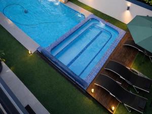 an overhead view of a swimming pool with chairs at 13 on Tenth in Walmer