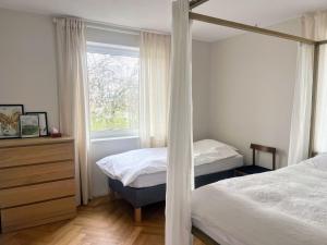 a bedroom with two beds and a window at Jelenec House in Jelenec