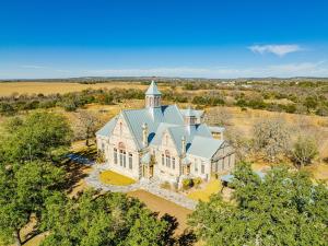 an aerial view of a large white house with a tower at Morris Ranch in Fredericksburg