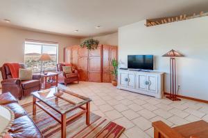a living room with a couch and a flat screen tv at Golfer's Haven! Mtn-View Dewey Gem w/ Pool Access in Dewey