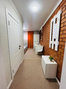 a hallway with a bathroom with a brick wall at Halqyma Hotel in Oral +77 photos
