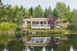 a circular house with a pond in front of it at Abbey in Richmond