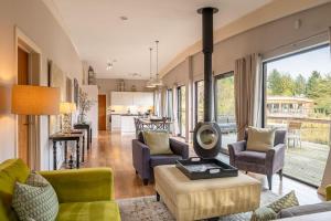 a living room with a couch and chairs and a fireplace at Abbey in Richmond