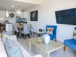 a living room with a couch and a table at Luxurious 2 bedroom condo with partial ocean view in Mazatlán