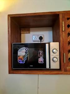 a microwave sitting on top of a cabinet at Rischland Villas in Watamu