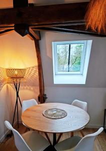 a table and chairs in a room with a window at La Tour du Château in Fougères