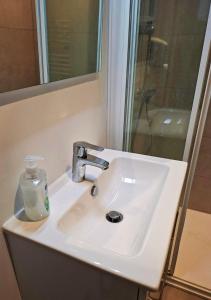 a bathroom sink with a soap bottle on it at La Tour du Château in Fougères +12 photos