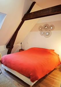 a bedroom with a red bed in the attic at La Tour du Château in Fougères