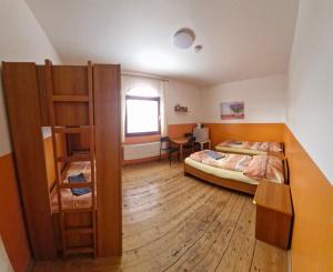 a bedroom with two bunk beds and a desk at Penzion Jaroš in Popůvky