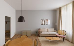 a living room with a couch and a table at Limehome Kaiserslautern Rummelstr in Kaiserslautern
