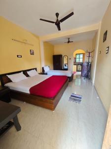 a bedroom with a large bed and a ceiling at Carvalhos Regina 100 mtrs Patnem beach in Canacona