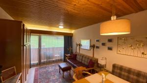 a living room with a couch and a table at Studio SISI in Tauplitz