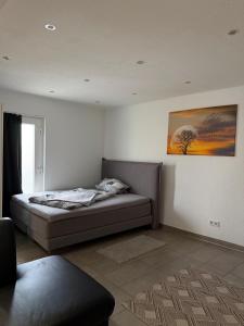 a bedroom with a bed and a painting on the wall at Sulzbach Saar in Sulzbach