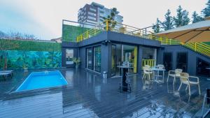 a house with a swimming pool and a patio at 7even Boutique Hostel in Tirana
