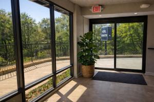 an entrance to a building with large windows and a potted plant at Hotel Arlington in Arlington +8 photos