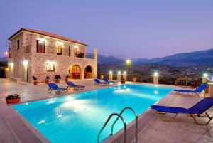 a swimming pool in front of a building at Villa Georgia in Fílippos