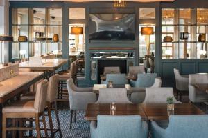 a restaurant with tables and chairs and a fireplace at Waterford Viking Hotel in Waterford