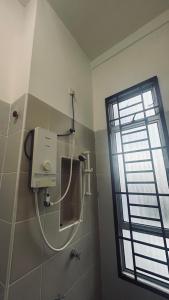 a shower in a bathroom with a window at Alpha 2 in Johor Bahru