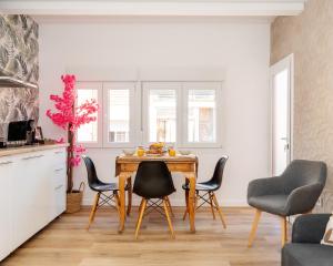 a kitchen with a wooden table and chairs at Bright Renovated 2BR Apt- Balcony - Beach 10' Walk - Barcelona 25' Train in Sant Adria de Besos