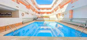 a swimming pool in a building with a large ceiling at AYF PLAYA MORRO DE GOS in Oropesa del Mar