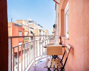 a balcony with a table and a bottle of wine at Bright Renovated 2BR Apt- Balcony - Beach 10' Walk - Barcelona 25' Train in Sant Adria de Besos
